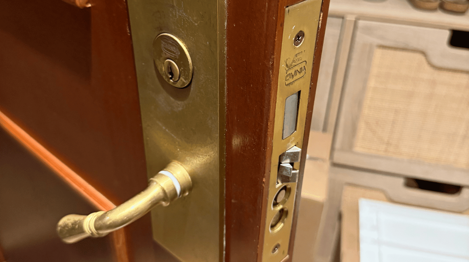 Close-up of a residential brass mortise lock on a wooden door, serviced in Beaverton, Oregon